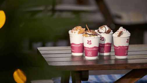 4 hot chocolates on a table in winter